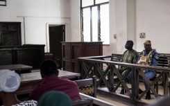 Manjang sits in the dock at the High Court in Banjul