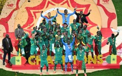 Senegal players celebrate with the trophy after beating hosts Morocco in the final to win the Africa Cup of Nations for the second time in their history