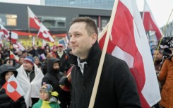 Greenland's leader Jens-Frederik Nielsen holds a Greenlandic flag as he attends a demonstration to the US consulate in Nuuk, Greenland over the weekend, as Greenlanders admit they cannot fight the United States but have no wish to be part of it