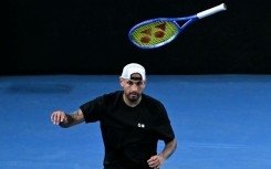 Australia's Nick Kyrgios throws his racket during his men's doubles match on Thursday
