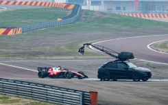 A camera crew film Charles Leclerc in the new SF-26