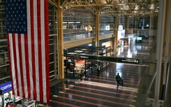A passenger walks through the check-in area of Ronald Reagan National Airport in Washington, DC, on January 24, 2026, after thousands of flights across the United States were cancelled due to a winter storm