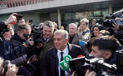 President Joan Laporta (C) indicated that Barcelona would receive more than the figure stipulated in Dro Fernandez's release clause