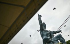 Released doves fly past the "Peace Statue" in Nagasaki, part of a ceremony to mark the 80th anniversary on August 9, 2025 of the world's last nuclear attack