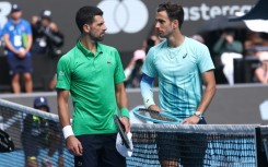 Italy’s Lorenzo Musetti (R) retired hurt in his Australian Open quarter-final against Novak Djokovic