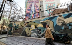 Anti-US and anti-Israel banners hang on a building in Palestine Square in Tehran