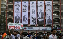 Campaign banners hang on a building's facade during an election rally of the Bangladesh Nationalist Party ahead of the country's general election. Authorities say the scale of online manipulation -- including sophisticated AI-generated images --  has become so severe that a special unit has been created to curb false content