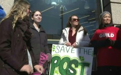 People rally in front of the Washington Post following massive layoffs