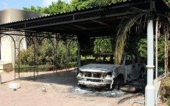 The wreckage of a car sits inside the US Embassy compound on September 12, 2012 in Benghazi, Libya, following an overnight attack on the building