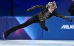 Ilia Malinin takes off in the routine that earned the USA figure skating team gold at the Milan-Cortina Winter Olympics