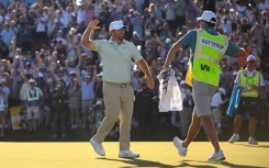 American Chris Gotterup celebrates with his caddie after beating Hideki Matsuyama in a playoff to win the PGA Tour Phoenix Open