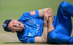 Italy captain Wayne Madsen grimaces in pain after dislocating his shoulder while fielding against Scotland