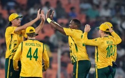 South Africa's Lungi Ngidi (C) celebrates with teammates after taking the wicket of Canada's Yuvraj Samra
