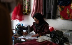 Rahima Alavi embroiders a scarf at her boutique in Bamiyan