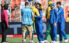 Afghanistan's captain Rashid Khan hugs South Africa's Corbin Bosch