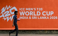 A man walks past a billboard advertising the 2026 ICC Men's T20 Cricket World Cup, at the Sinhalese Sports Club (SSC) cricket stadium in Colombo
