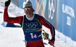 Johannes Klaebo acknowledges the crowd as the Norwegian becomes the first Winter Olympian in history to win nine gold medals