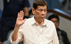 Former Philippine president Rodrigo Duterte takes an oath as he attends a senate probe on the drug war during his administration, in Manila on October 28, 2024