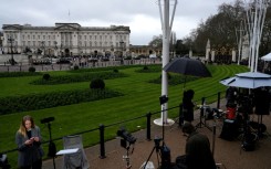 Members of the media gather outside Buckingham Palace in London after the arrest of former prince Andrew
