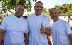 (L to R) Venezuelans Armando Fusil, Richard Corona and Robin Colina pose for a picture after being released from Rodeo I prison on Sunday