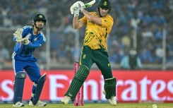 David Miller plays a shot as India wicketkeeper Ishan Kishan watches