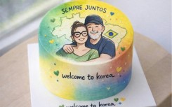This undated handout photo released by the South Korean Presidential Office in Seoul shows a cake decorated with an illustration of Brazil's President Luiz Inacio Lula da Silva and his wife Rosangela da Silva to welcome their visit to South Korea