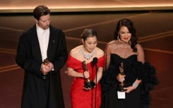 Co-director Chris Appelhans co-director Maggie Kang and producer Michelle Wong accept the Oscar for best animated feature for 'KPop Demon Hunters'