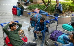 Stranded passengers wait at the departure terminal in Mumbai on March 1, 2026 after India's two largest private carriers IndiGo and Air India suspended flights to all destinations in the Middle East
