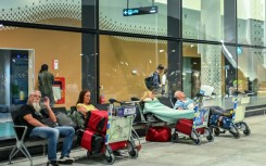 Stranded passengers wait at the Velana International Airport in Male on March 1, 2026 after the cancellation of flights destined for the Middle East