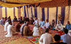Mourners gather to offer condolences after the death of Pakistani national Muzaffar Ali, who was killed in Dubai amid the ongoing Middle East war, after his funeral in Jamshoro, in Sindh province