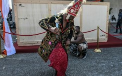 A crate holding the Djidji Ayokwe, or 'talking drum', looted by French colonial troops from Ivory Coast in 1916, arrived home in Abidjan