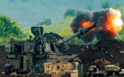 An Israeli artillery gun fires rounds towards southern Lebanon