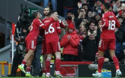 Liverpool midfielder Dominik Szoboszlai (2nd L) celebrates after scoring the opening goal of a 1-1 Premier League draw with Tottenham Hotspur at Anfield