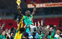 Senegal's forward Sadio Mane celebrates with the trophy after winning the Africa Cup of Nations final football match against Morocco in January 2026