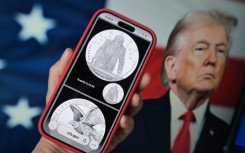 A phone displaying the commemorative gold coin featuring Trump to mark America's 250th anniversary