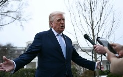 US President Donald Trump speaks to journalists before boarding Marine One as he departs from the South Lawn of the White House