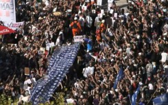 Demonstrators carry a large banner with portraits of disappeared people during a march to Plaza de Mayo