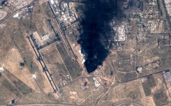 A satellite image showing smoke plumes billowing in the vicinity of Kuwait International Airport after it was hit by drones