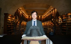 The director of Musee Conde, Mathieu Deldicque, poses with a hat believed to have belonged to Napoleon Bonaparte