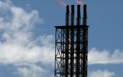Safety flares burn at Woodside's North West Shelf gas venture in Western Australia, which was impacted by a cyclone on Friday, 27 March.