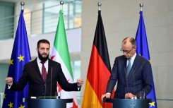 German Chancellor Friedrich Merz (R) and Syrian President Ahmed al-Sharaa address a joint press conference