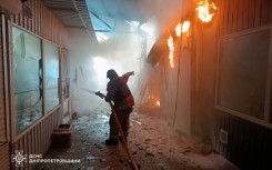 Ukraine's State Emergency Service released images of its firefighters at the scene of the strike on the market in Nikopol