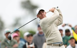 Defending champion and world number two Rory McIlroy of Northern Ireland plays a tee shot during a practice round for the 90th Masters at firm and fast Augusta National
