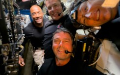 This handout picture released on April 7, 2026, by NASA shows Artemis II crew members (L/R) Pilot Victor Glover, Mission Specialist Jeremy Hansen, Commander Reid Wiseman, and Mission Specialist Christina Koch taking a selfie