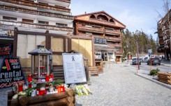 Candles and flowers left by Le Constellation bar in Crans-Montana