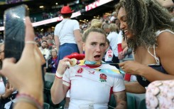 England centre Megan Jones (L) celebrates after their 33-13 Women's Rugby World Cup final win over Canada at Twickenham last year