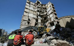 Lebanese rescuers clear the rubble at the site of an Israeli airstrike in Beirut