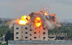 An Israeli airstike hits a building in Lebanon, in the southern village of Abbasiyyeh, on March 13