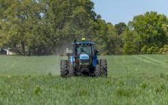 Fertilizer is spread across a field in North Carolina, where Andy Corriher farms