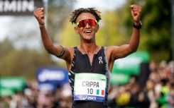 Italy's Yemaneberhan Crippa celebrates after winning the Paris marathon